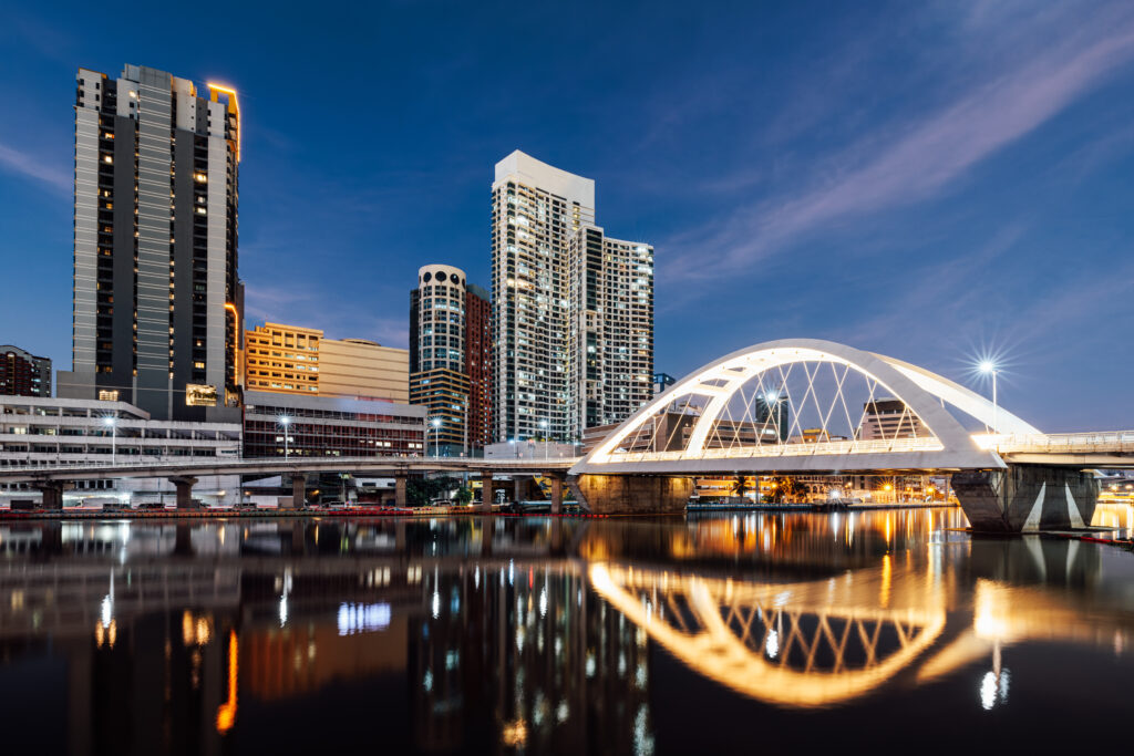 Manila City skyline during sunset with a bridge connecting Intramuros to Binondo